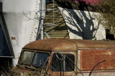 photograph “XII.2015” par David Farreny — www.farreny.net — France, Occitanie, Gascogne, Gascony, Gers, Ordan-Larroque, hangar, shed, tôle ondulée, corrugated iron, métal, metal, arbre, tree, tronc, trunk, ombre, shadow, branches, fourgonnette, van, rouille, rust, rusty, vieille, old, abandonnée, abandoned, silo, échelle, ladder, tuyau, pipe, dépression, depression