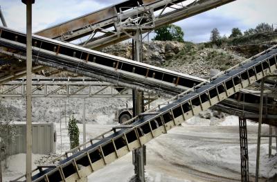 photograph “VIII.2005” par David Farreny — www.farreny.net — France, Occitanie, Aveyron, Rouergue, Onet-le-Château, la Vialatelle, carrière, quarry, machines, métal, metal, poussière, dust, roche, rock, industrie, industry, structure, tapis roulant, conveyor belts, convoyeur à bande, falaise, cliff, arbres, trees, tôle ondulée, corrugated iron, bulldozer, véhicule, vehicle, roue, wheel, nuages, clouds